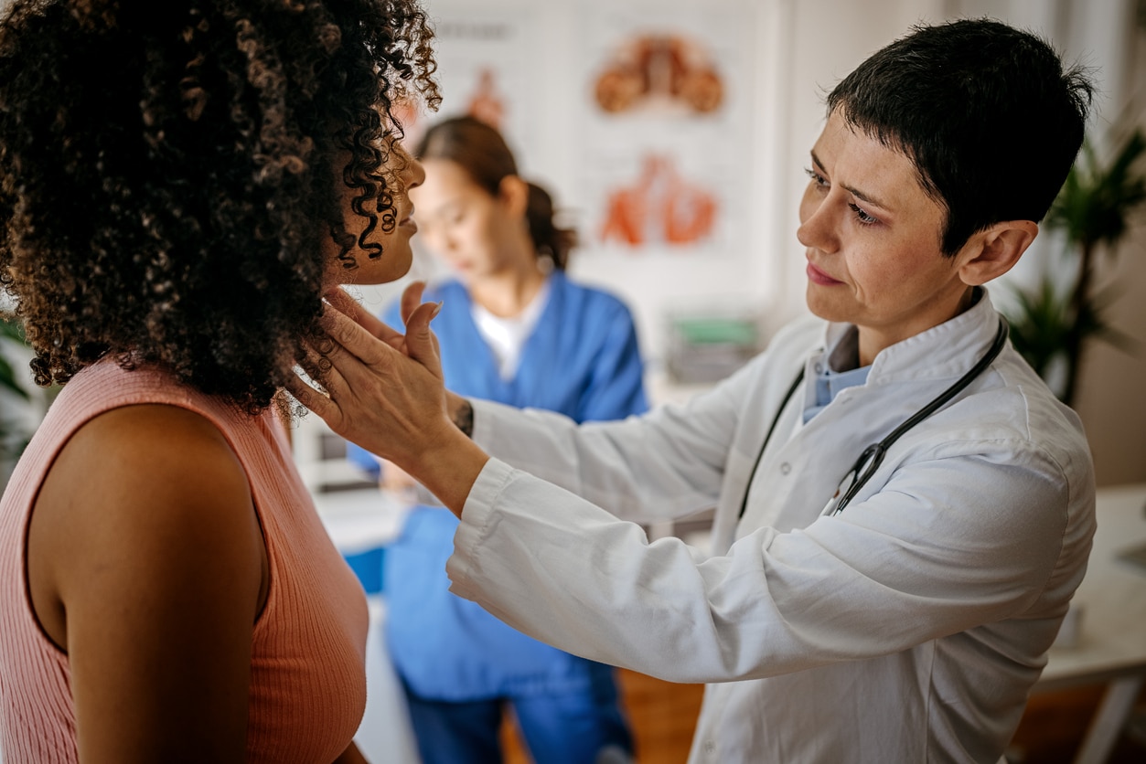 Doctor examining patient with a sore throat.