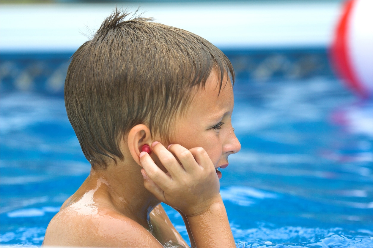 Boy holds earplug