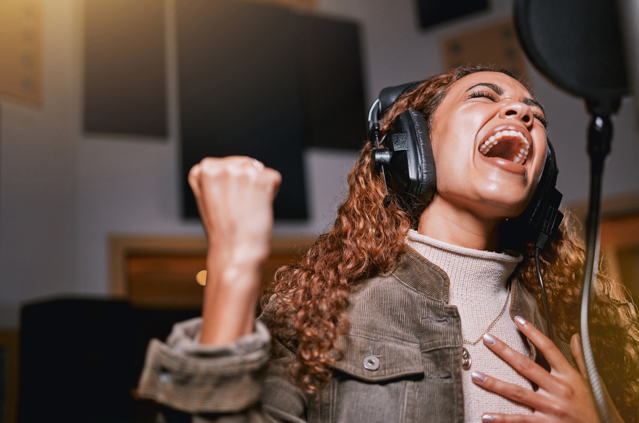 Young woman singing in a studio