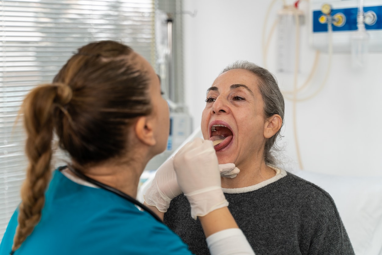 ENT examining a patient's throat