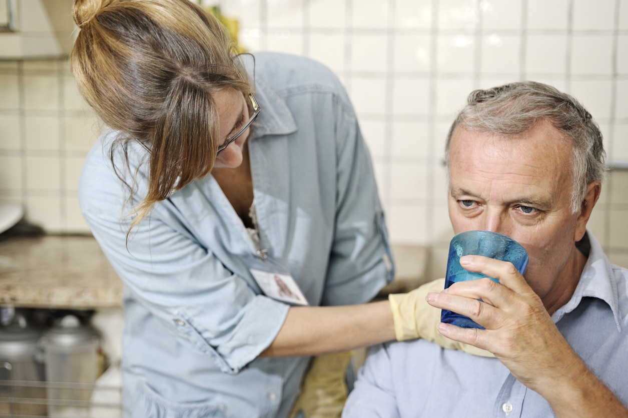 Healthcare worker checking man's throat