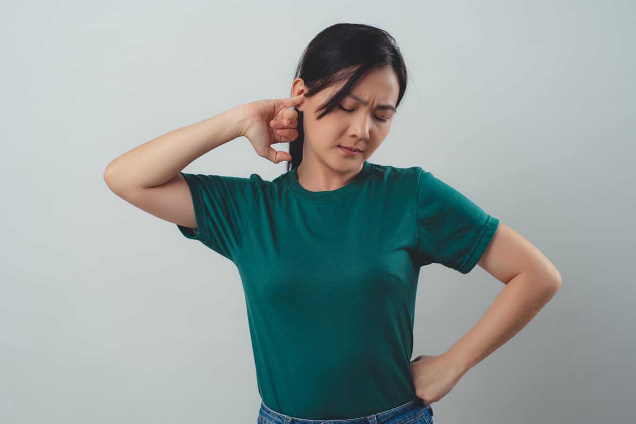 Woman trying to unplug clogged ear