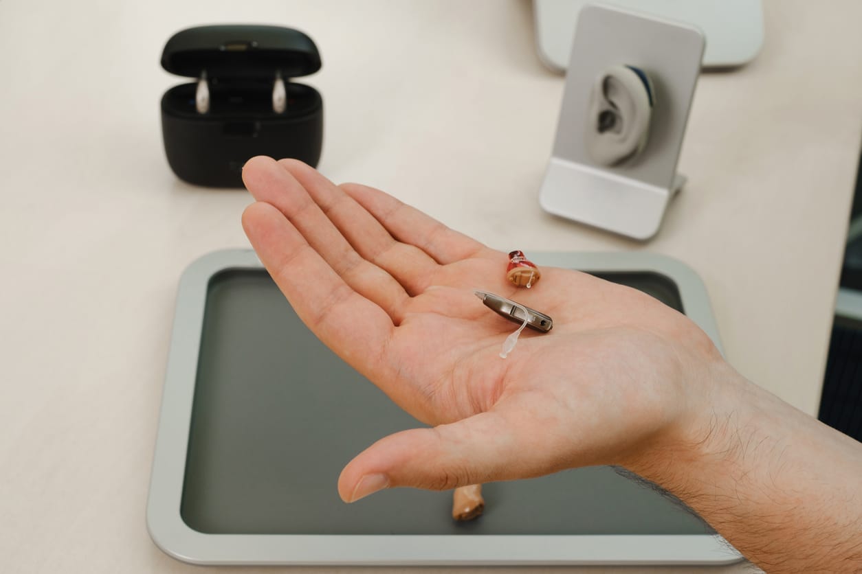Very small hearing aid in hands