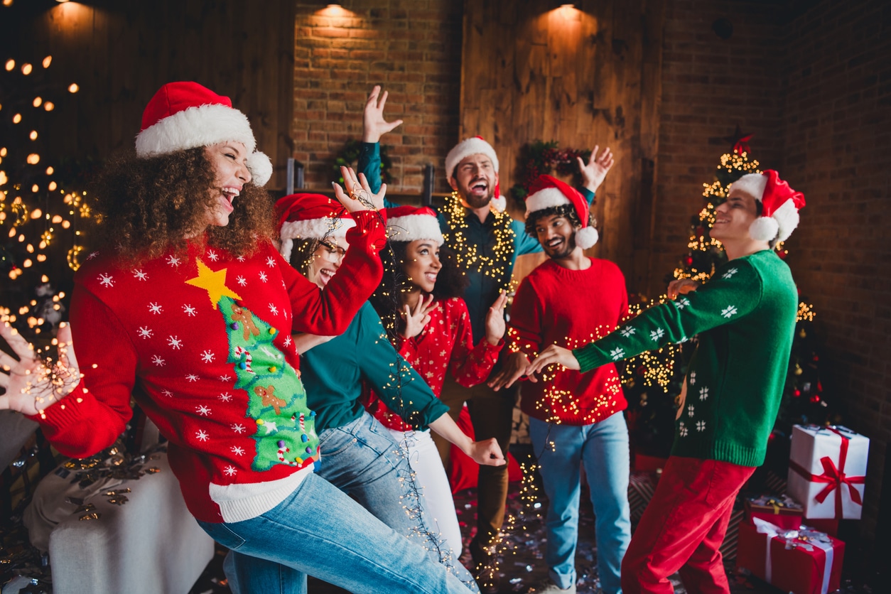 Happy group of friends dancing at a holiday party